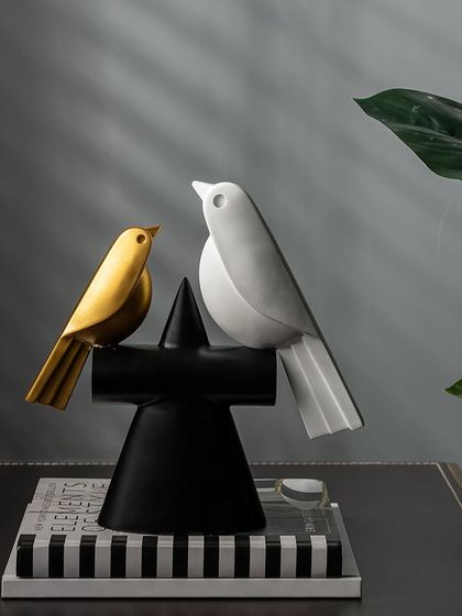 This elegant duo of minimalist bird showpieces is a sophisticated addition to any contemporary home. The clean lines and contrasting black, white, and gold colors create a simple yet beautiful display.
