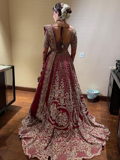 Another shot of the full-length bridal look, emphasizing how a well-structured updo supports the entire bridal ensemble, from the dupatta to the trail of the lehenga.