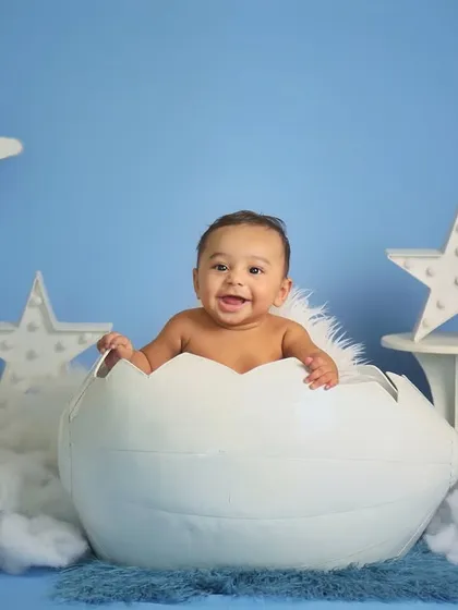A big, happy smile from this six-month-old. Milestone sessions are a wonderful way to document how much your baby has grown in their first year.