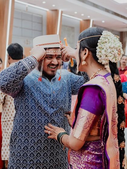 A candid moment of fun and tradition during a Maharashtrian wedding ceremony. These are the real, unscripted interactions that make your wedding album unique.