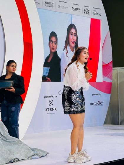 Teaching on a big stage with my live feed on the screen behind me. I make sure everyone can see the details.