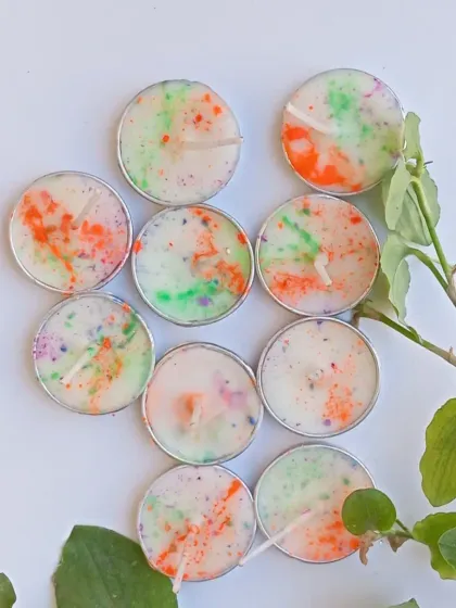 An overhead shot of the Holi tealights, showing the unique splatter of colors on each candle, making every one slightly different.