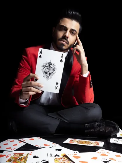 Here I am, surrounded by cards, holding up a giant Ace of Spades. It's a powerful image that represents my mastery of card magic.