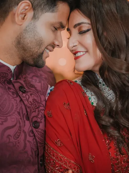 A close-up of the couple, their noses touching, sharing a sweet and intimate smile. A perfect capture of their love and connection.