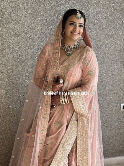 A full-length portrait of a bride in her stunning pastel lehenga. Her grace and elegance are undeniable, and her mehendi adds a perfect touch of tradition.