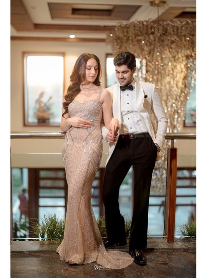 A classic pose showcasing the couple's formal outfits and the stunning architecture of the location. This is timeless pre-wedding photography.