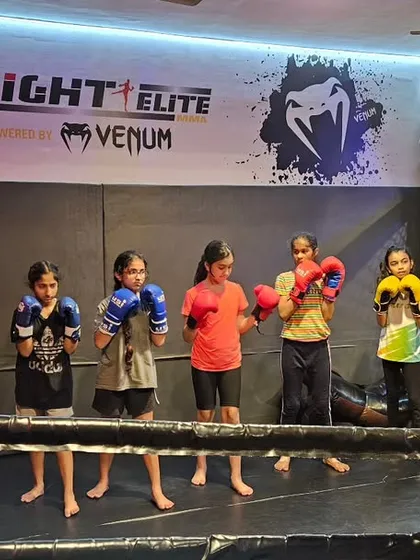 Our young fighters lined up and ready in the ring. We teach them proper stance, focus, and discipline from day one. This is where their journey to becoming confident martial artists begins.
