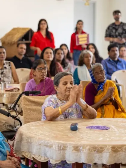 A resident claps along, fully immersed in the music during our 'Togetherness Initiative' performance. It's moments like these that show the universal language of music and its ability to bring joy and create shared experiences.