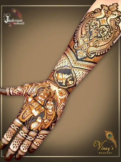 A full-hand view of the Radha Krishna design, showing how the divine portrait on the palm connects seamlessly with the traditional peacock and elephant motifs on the arm.