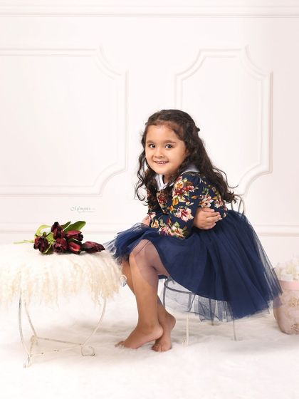 A sweet portrait of a little girl, ready for her fourth birthday photoshoot. Her smile and the simple, elegant setup are just perfect.