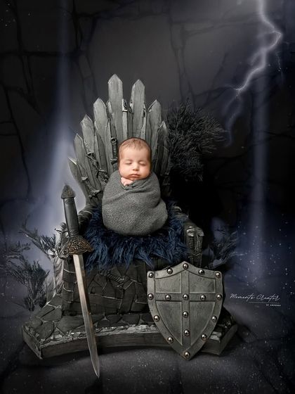 The king of our hearts. This epic Game of Thrones inspired setup features a newborn ruling from the Iron Throne, creating a powerful and unforgettable portrait.