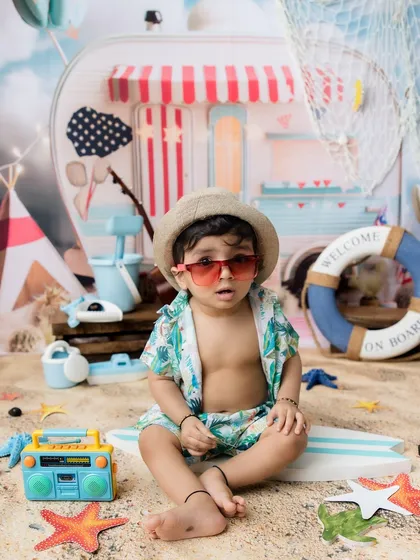Looking cool in his shades, this toddler is the king of the beach.