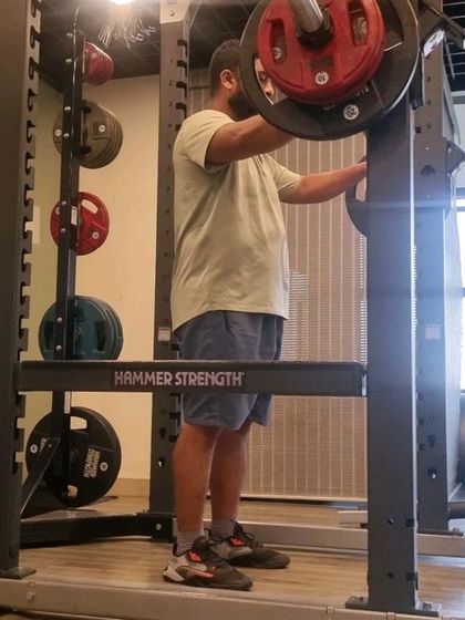 A client preparing for a heavy squat, showing the focus required before a big lift.