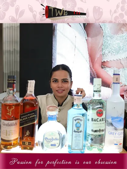Our female bartender at the bar, surrounded by a premium selection of spirits, ready to craft any drink a guest desires.