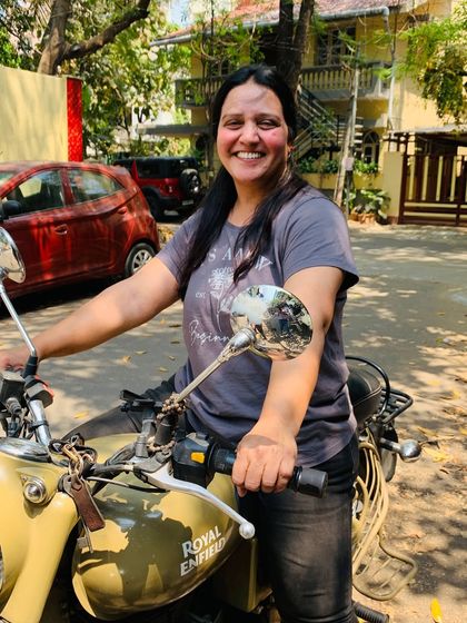 A graduate's beaming smile says it all. She has discovered the joy and empowerment of riding a motorcycle.