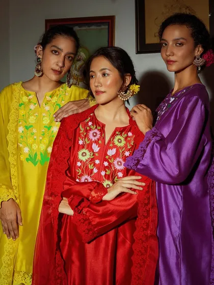 Three models for Baavli in a stunning array of jewel-toned outfits. This shot captures the richness and variety of the collection.