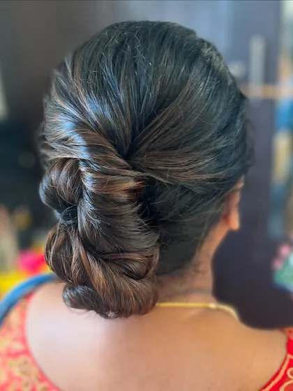 A simple yet elegant twisted bun. This is a versatile style that can be dressed up or down with accessories.