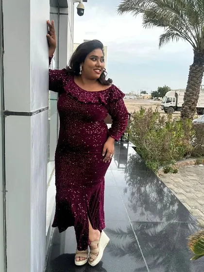 Leaning against a pillar, feeling glamorous. This dress was perfect for the festive atmosphere of the event.