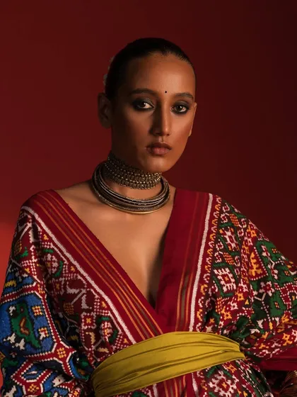 A close-up portrait of the patola look, focusing on the oxidized silver choker that complements the rich colors of the fabric.