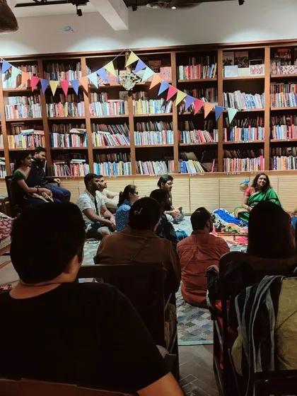 A storytelling session in our cozy library space. The audience sits on the floor, gathered close, creating an intimate and traditional atmosphere for listening to tales.