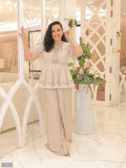 Posing by an elegant doorway at a housewarming event. My outfit was chosen to complement the sophisticated and modern decor of the home.