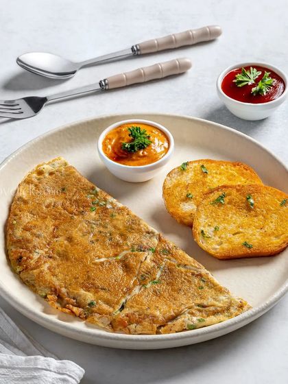 A classic masala omelette served with two dips and toasted bread.