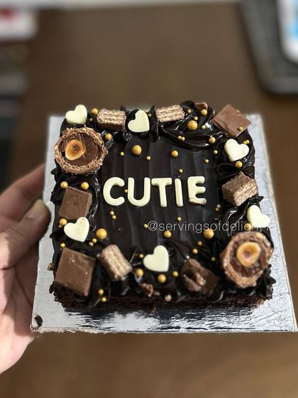 This close-up shows the delicious toppings on my chocolate brownie cake, including white chocolate hearts and crunchy wafers.