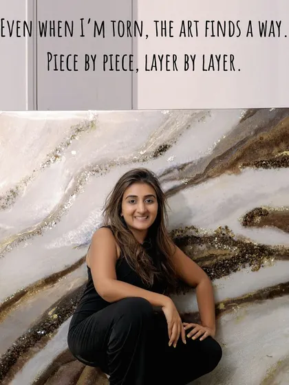 Even when I'm torn, the art finds a way. This photo shows me with a large, earthy-toned geode piece, a reminder that art is built piece by piece, layer by layer.
