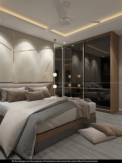 This angle shows the beautiful wardrobe with smoked mirror doors and gold-tone trim, adding a touch of opulence to the bedroom.