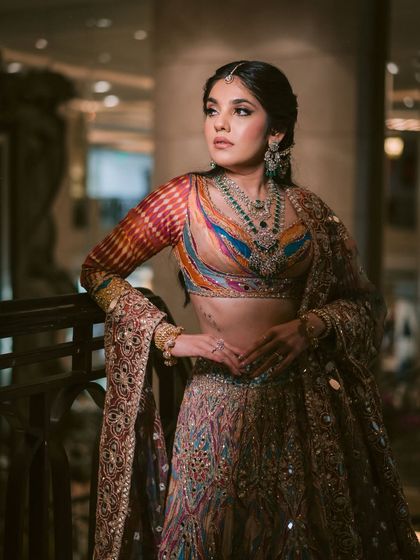 A stunning look for a garba night. The makeup is glamorous with a defined eye, perfect for an evening of celebration.