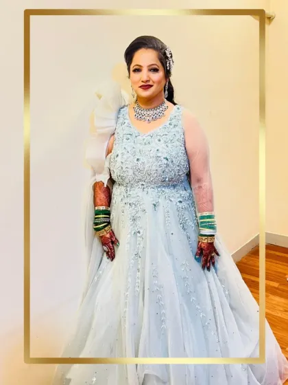 A client looking radiant and happy in a beautiful ice blue reception gown.