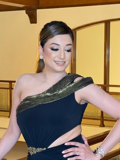 A close-up of the sleek ponytail for the prom look. The hair is styled with a clean side part and pulled back smoothly, highlighting her beautiful makeup.