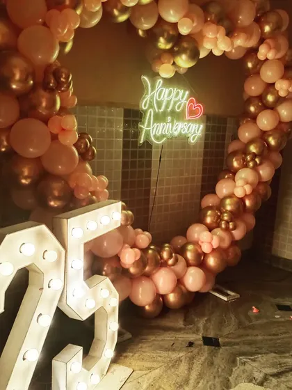 A beautiful rose gold and chrome balloon heart arch for a 25th anniversary. This color combination offers a modern and sophisticated alternative to traditional red.