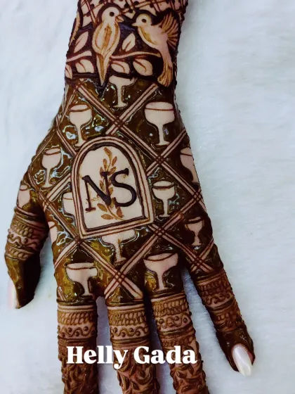 Your mehndi can reflect your personality. This fun design was for a client who loves wine and birds, so I combined them into a unique and personal piece with her initials.