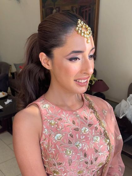 A happy client with her high ponytail. This is a versatile style that I can customize to be as sleek or as voluminous as the client wishes.