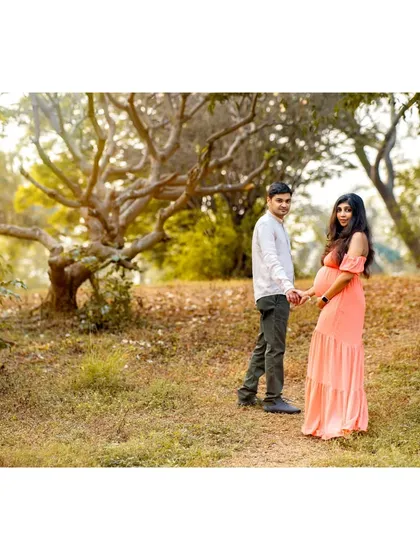 A wider shot that sets the scene of their walk together in a beautiful park. This type of environmental portrait shows the couple in their element, capturing a snapshot of this special time in their lives.