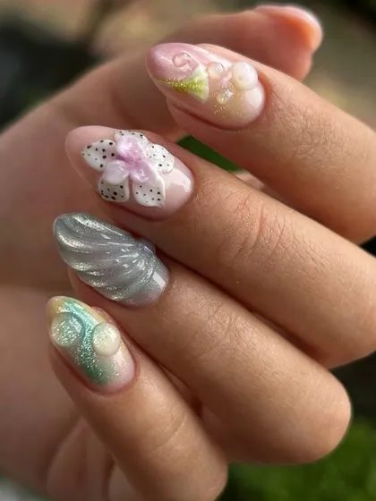 A beautiful, summer-themed 3D nail art set. This design features sculpted flowers and shells in soft pastel colors, perfect for a beach vacation.