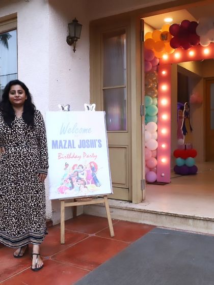 Our planner next to the custom welcome sign for a client's birthday party.