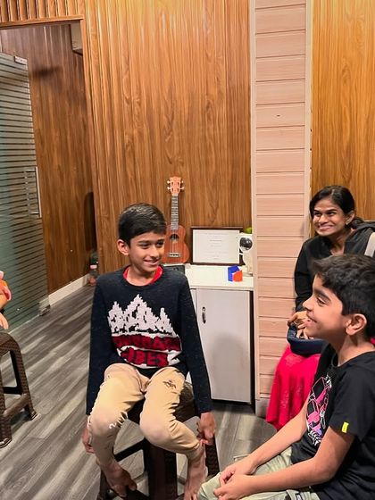 An instructor smiles as she watches over a group of young students, creating a warm and encouraging atmosphere for learning.