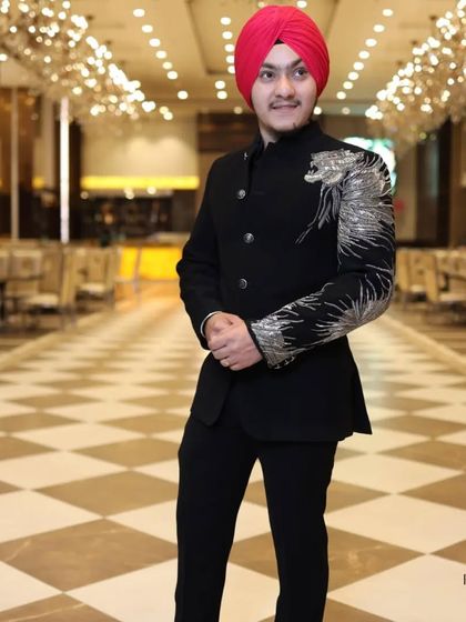 A full-length view of the custom dragon-embroidered bandhgala. The asymmetrical design adds a modern edge to the traditional silhouette, perfect for making an entrance.