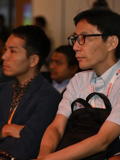 International attendees listen intently to a presentation, showcasing the global appeal of our educational content.