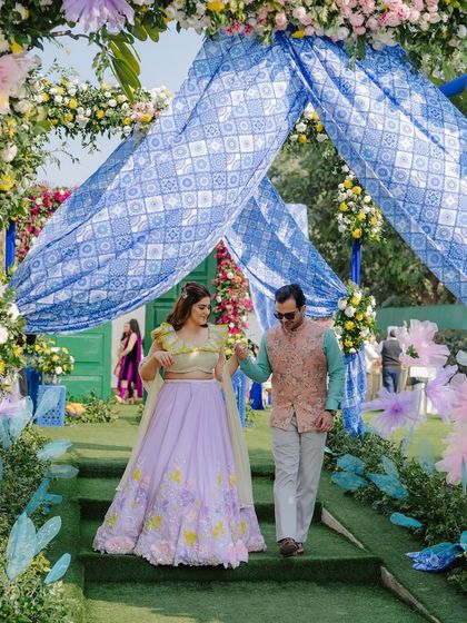 The couple's grand entrance. The bride's colorful makeup and outfit make a beautiful statement as she walks into her Mehendi celebration.