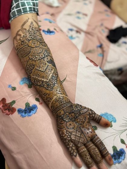 An intricate full-arm design for an engagement, featuring a mix of paisleys, florals, and geometric fills.