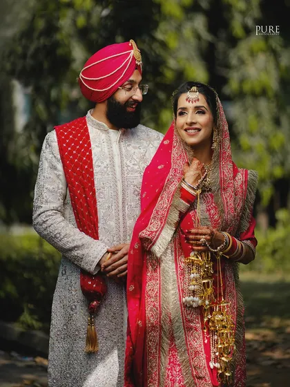 A beautiful outdoor portrait of a Sikh couple. The natural light and their loving expressions create a soft and romantic image.