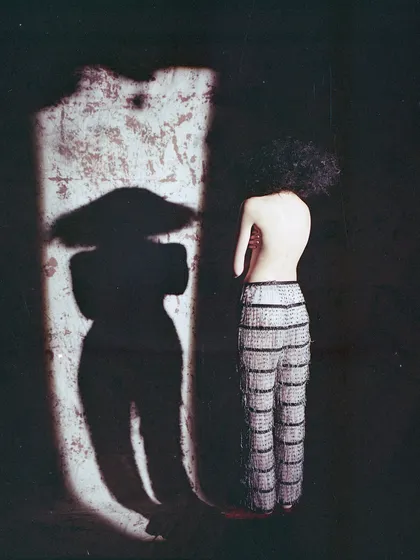 An artistic shot from an archival film project, playing with light and shadow. The silhouette creates a mysterious and compelling narrative, focusing on form over detail.