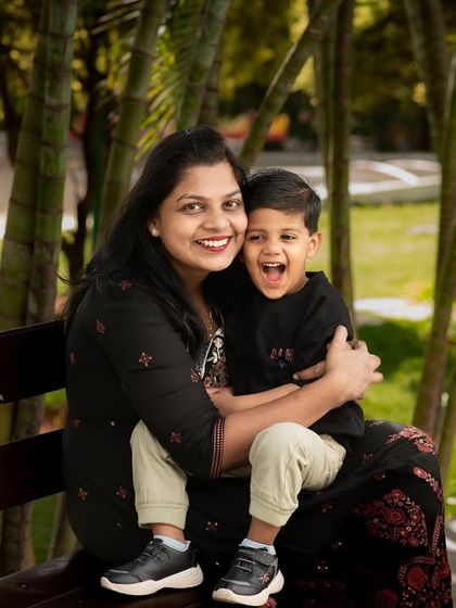 A moment of pure joy between a mother and her son. His unrestrained laughter and her loving embrace make this outdoor portrait incredibly special.