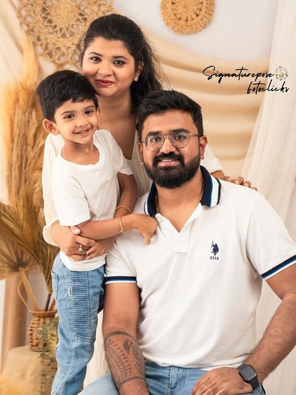 A classic family portrait with mom, dad, and their son, all dressed in coordinated casual outfits. A timeless keepsake.