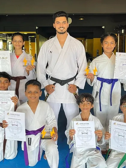 The next generation of champions. Celebrating with my students after a successful karate belt grading test. Seeing their pride and progress is the biggest win for me as a coach.