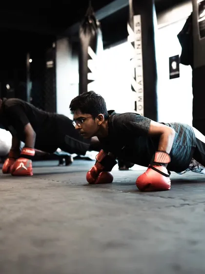 Students perform push-ups on their gloves, a challenging variation that strengthens the wrists and core.