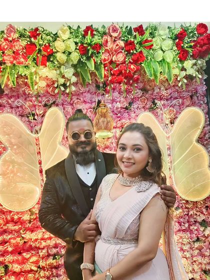 A reception look that is all about glamour. The groom looks sharp in a black tuxedo, while she wears a beautiful ready-to-wear saree with a stylish belt.
